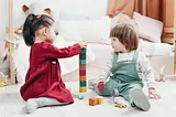 toddlers playing with educational toys