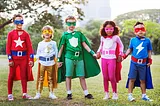 Five children of all races dressed as superheroes