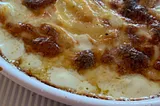 Gratin Dauphinois bubbling, brown, just out of the oven,