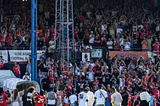 The kenilworth road main stand applauds the players on the pitch at full time of the final day