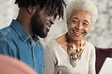 Man with his Mom, who is super proud of her baby.