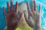 A child behind a frame of bubble wrap