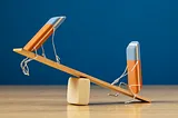 A photo of two animated erasers on a seesaw.