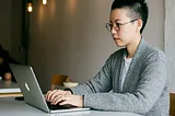 Image: Imagen 3. Image shows a person using a MacBook at a desk in a tranquil environment.