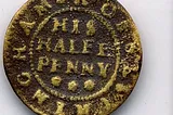 Image of a worn and pitted copper alloy A worn and pitted copper alloy traders token