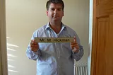 Me, at the end of my career as a teacher. Fat, unhappy, depressed, in mental turmoil…and holding the sign from my classroom door as if I am standing in a Police mugshot. Which was how it felt, to be honest.