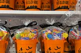 Bus eller Godis = trick or treat in swedish. An orange candy bucket filled with candy.