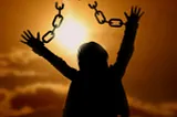 Person with chains with arms raised.