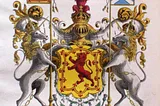 This illustration shows the Scottish royal coat of arms. In the middle is a yellow shield with a red lion rampant and above the shield is a golden helmet with a crown. Above that is a another smaller lion also wearing a crown and above him the words “In Defence”. Below are thistles and the Latin motto “Nemo me impune lacesset”. There are chained unicorns on either side which are on their hind legs holding up the shield. Each unicorn also holds a spear with a Scottish flag.