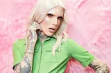 A photo of Jeffree Star with a blonde wig and his tattoos showing
