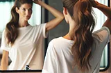 perfect ponytail, woman looking in bathroom mirror making ponytail