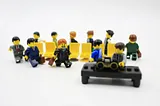 IMAGE: Mini-Lego figures dressed as executives and playing a game of musical chairs