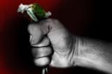 A woman, small as a doll, tightly squeezed in a firm fist