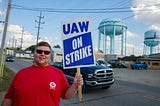 A worker from United Auto Workers Local 440 pickets at an entrance of GM’s Bedford Powertrain factory.