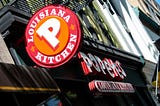 A photo of a Popeyes store front and logo.