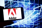 A photo of Adobe’s logo on a smartphone.