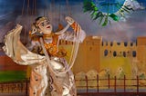 Burmese princess marionette onstage with arms up and painted buildings backdrop