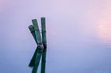 Dock piers sticking out of calm lake waters