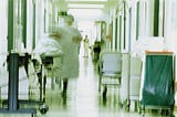 A blurry image of a hospital hallway.