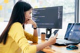 A woman looks at her laptop deep in thought, looking at the results of a business experiment.