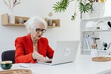 An old woman not happy looking at her laptop