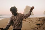 Wake up happy girl on beach during dawn hands waving in the air she looks happy pretending to balance walking and having fun