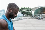 The author sat cross legged meditating on his yoga mat at Marina Bay Sands in Singapore.