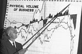 Roger W. Babson points to a graph titled “Physical Volume of Business”