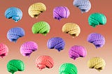 Multicolored blue, green, yellow, purple, and orange human brains floating mid air on a gradient brown background.