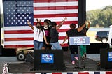 A group of AKA members dance onstage at a Biden/Harris event.