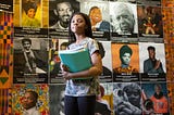 A seventh grader walks by a Black History Month display at Sutton Middle School on her way to class.