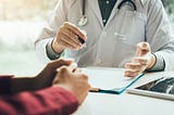 A doctor talking to the patient about their diagnosis.