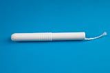 A tampon on a blue backboard.