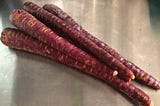 A stack of purple carrots.