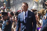 Daniel Craig as James Bond walks through a crowd from the movie set of 007: Spectre.