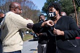 Reverend Raphael Warnock and Stacey Abrams bump elbows.