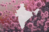 A photo treatment of the map of India with coronaviruses looming in the background.