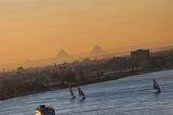 Pyramids of Giza and the River Nile with sailboats