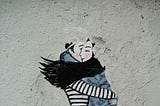 Two people hugging each other