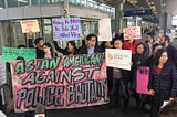 Protesters outside San Francisco International Airport. They’re holding banners and signs like “Asian Americans against police brutality,” “stop brutality from all law enforcement,” and “no one deserves to be treated like this.”