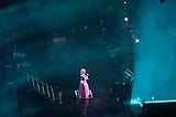 Nicki Minaj alone on stage, looking like a Disney Princess in a pink poofy dress