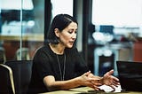 A photo of a woman in a work meeting.