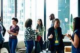 A group of individuals networking with each other at an event.