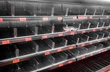 Empty meat shelves at the grocery store.