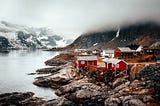 Grupo de cabañas a orillas de un lago, típico paisaje noruego.