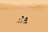 A small office desk and chair with a laptop sit alone in the middle of a vast, empty desert. The minimalist scene, viewed from a distance, emphasizes solitude and isolation against a backdrop of rolling sand dunes and warm beige tones.