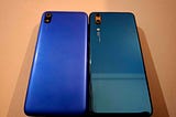 Two old smartphones lying side by side on a table.