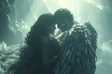 A male angel embraces a human woman, enfolding her in his wings.