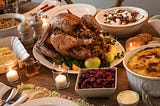 A dining table filled with Thanksgiving food.
