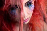 Girl with pink hair and blue eyelashes